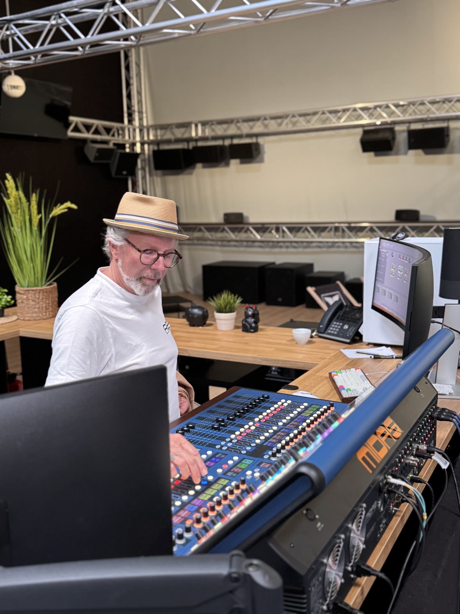 Sound engineer mixing live audio at a digital console