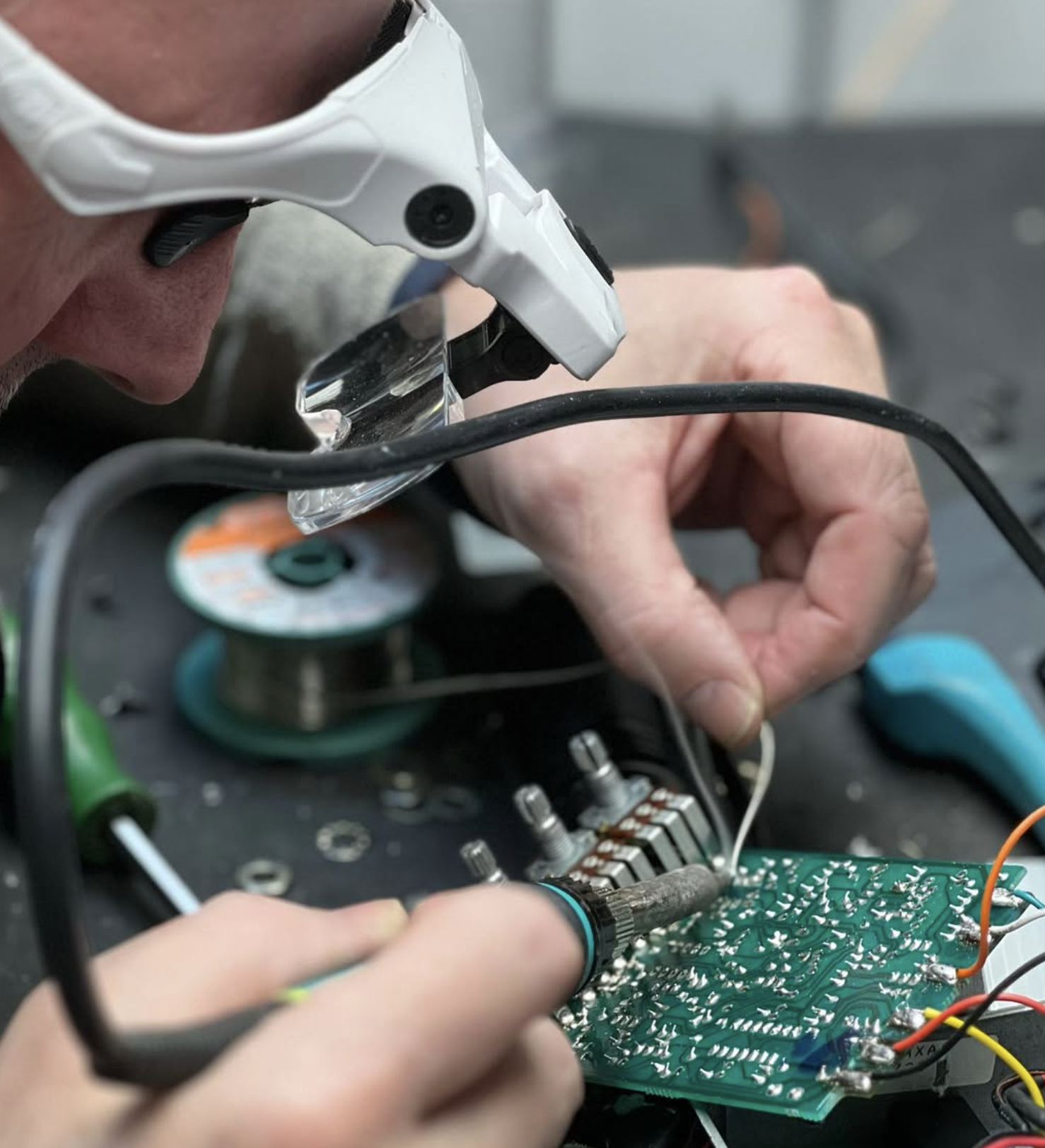 Technician repairing audio equipment at the RBS workshop